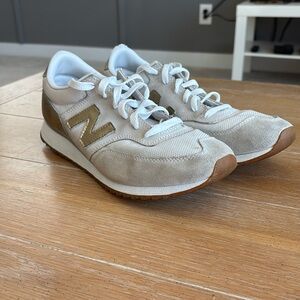 gold and cream new balance athletic shoes